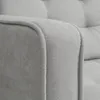 A close-up view of the armrest of a light gray sofa. Náhled obrázku produktu