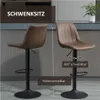Two bar stools are shown in a modern kitchen setting. Podgląd zdjęcia produktu