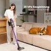 A woman is vacuuming a carpet in a living room while a dog sleeps on the couch. Produktbild-Vorschau