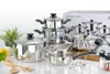A collection of stainless steel pots and pans with glass lids, arranged on a white surface with some decorative elements like peppers and wooden spoons. Produktbild-Vorschau