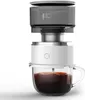 A portable electric coffee maker is shown brewing coffee into a glass mug. Podgląd zdjęcia produktu
