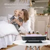 A woman holding a baby next to a vintage steamship-shaped aroma diffuser emitting mist. Produktbild-Vorschau