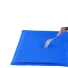 A hand is pressing a fork into a blue cooling mat. Náhľad obrázku produktu