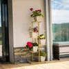 A multi-tiered metal plant stand with various potted plants displayed on a patio. Náhľad obrázku produktu