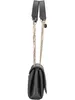 A side view of a black Guess handbag with a gold chain strap against a white background. Produktbild-Vorschau