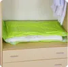 A vacuum-sealed bag containing bedding is placed on a shelf above drawers in a closet. Náhled obrázku produktu