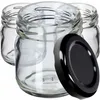 Three clear glass jars with black lids, one lid is placed in front of the jars. Podgląd zdjęcia produktu