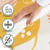 A hand is wiping a foam mat with a white cloth, showing its water-resistant and easy-to-clean features. Three circular icons with graphics are also visible, highlighting product features. Podgląd zdjęcia produktu