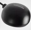 A close-up shot of the top of a black floor lamp head. Produktbild-Vorschau