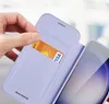 A hand is inserting a credit card into a phone case. Produktbild-Vorschau