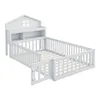 A white wooden children's bed with a house-shaped headboard and built-in shelving, featuring safety rails and a gate. Náhľad obrázku produktu
