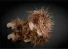 A fluffy brown stuffed monkey lies on a dark background. Náhled obrázku produktu