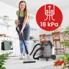 A woman is cleaning a carpet in a kitchen with a wet/dry vacuum cleaner. Produktbild-Vorschau