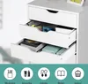 Close-up of a white drawer unit with open drawers showing office supplies and books. A decorative footer with icons and text is visible at the bottom. Produktbild-Vorschau