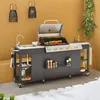 An outdoor kitchen setup with a gas grill, sink, and storage cabinets. Produktbild-Vorschau