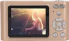 The back of a gold digital camera displaying a photo of a woman sitting outdoors. Produktbild-Vorschau
