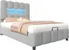 A grey upholstered bed with a blue LED light strip in the headboard, shown against a white background. Náhled obrázku produktu