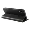 A black leather flip case for a smartphone is shown from the side, propped open to stand. Produktbild-Vorschau
