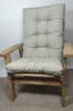 A close-up view of a beige cushion on a wooden chair. Produktbild-Vorschau