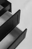 Close-up view of black bathroom cabinet drawers, some open. Náhled obrázku produktu