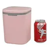 A pink trash can and a red soda can are shown side-by-side against a white background. Produktbild-Vorschau
