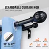 A close-up view of a double curtain rod with blue curtains hanging from it. Voir les images du produit