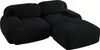 A black modular sofa with an ottoman, shown from a diagonal angle against a white background. Produktbild-Vorschau