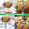 Collage of artificial flowers in various settings, including a vase indoors, planters outdoors, and on a table. Produktbild-Vorschau