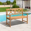 A wooden park bench is placed on a patio next to a swimming pool, with a house and garden in the background. Voir les images du produit