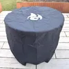 A round, black cover with a white flame logo on top, placed on a patio. Anteprima dell’immagine prodotto