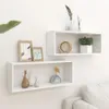 Two white cube shelves mounted on a white wall, decorated with various items. Voir les images du produit