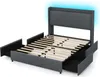 A grey upholstered bed frame with a headboard featuring integrated LED lighting, shown with drawers pulled out. Anteprima dell’immagine prodotto