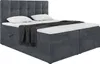 A dark gray upholstered box spring bed with a tufted headboard, two white pillows, and a dark gray throw blanket is shown against a white background. Produktbild-Vorschau