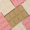A close-up, overhead view of several pieces of dog chocolate, arranged diagonally. Produktbild-Vorschau