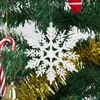 Close-up of Christmas tree ornaments including a snowflake, candy cane, and bell. Anteprima dell’immagine prodotto