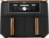 A front view of a black Ninja Foodi MAX DualZone air fryer with gold accents on the handles and top trim. The digital display and control panel are visible. Produktbild-Vorschau