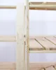 A close-up view of a wooden shelving unit. Produktbild-Vorschau