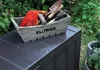 A garden storage box with gardening tools and gloves on top, placed outdoors in a garden setting. Anteprima dell’immagine prodotto
