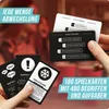 A hand holding game cards with text overlays and other cards scattered around, with blurred people in the background. Produktbild-Vorschau