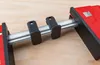 A close-up shot of a clamp on a wooden surface. Náhľad obrázku produktu