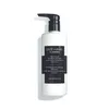 A white bottle of shampoo with a black pump dispenser and a black label. Anteprima dell’immagine prodotto