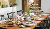 A beautifully set dining table with plates, food, and wine, suggesting a meal or gathering. Náhľad obrázku produktu