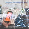 A person is holding a smartphone with a smart thermostat app open, with futuristic digital graphics overlaid on the image. Náhled obrázku produktu