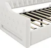 Close-up view of the side and slatted base of a white upholstered daybed. Náhled obrázku produktu