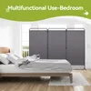 A bedroom scene with a bed and a room divider. Produktbild-Vorschau