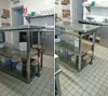 A kitchen or workshop environment with stainless steel workbenches and tiled floors. Produktbild-Vorschau
