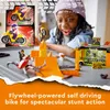 A young girl is playing with a LEGO City Stunt-Park set, featuring a motorcycle and ramp. Podgląd zdjęcia produktu