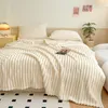 A cozy bedroom scene with a neatly made bed featuring a plush beige blanket. Produktbild-Vorschau