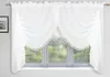 A white sheer curtain with decorative lace trim is displayed across a window. Náhled obrázku produktu