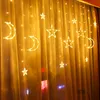 A string of LED lights shaped like moons and stars hanging on a yellow curtain. Produktbild-Vorschau